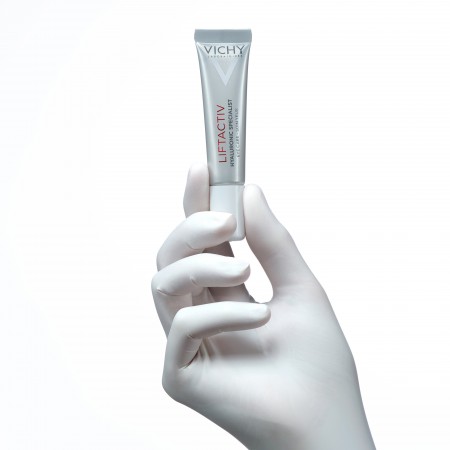 Tubo de crema antiarrugas para ojos Vichy Liftactiv sostenido por un especialista